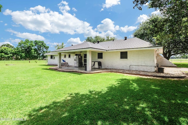 938 Marteau Rd, Broussard, LA 70518 - rear view of house with brick siding, a patio area, and a lawn