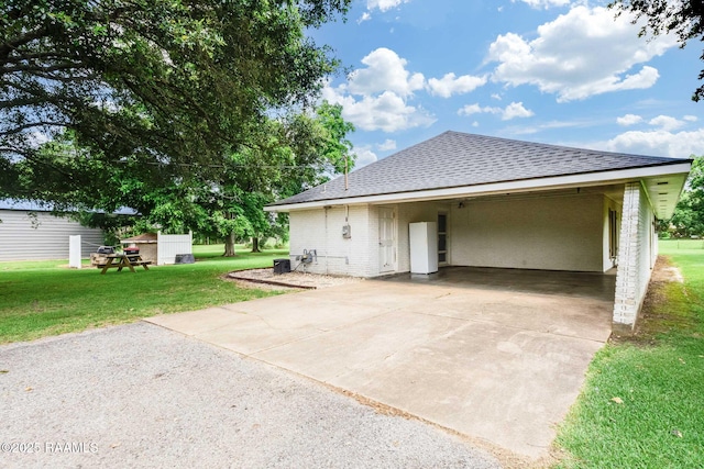 938 Marteau Rd, Broussard, LA 70518 - view of front of property with a front lawn, a shingled roof, concrete driveway, and an attached carport