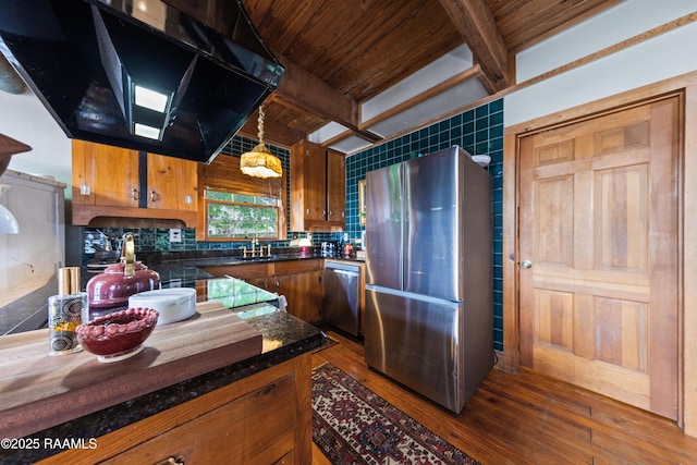 3000 E Simcoe St, Lafayette, LA 70501 - kitchen featuring stainless steel appliances, exhaust hood, dark countertops, brown cabinetry, and dark wood-style floors