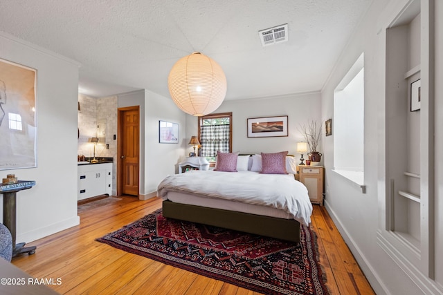 3000 E Simcoe St, Lafayette, LA 70501 - bedroom with hardwood / wood-style flooring and a textured ceiling