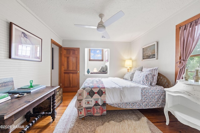 3000 E Simcoe St, Lafayette, LA 70501 - bedroom with wood finished floors, ornamental molding, a textured ceiling, and ceiling fan