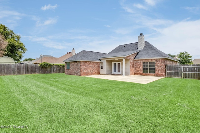 117 Fawn Ln, Broussard, LA 70518 - rear view of property featuring a fenced backyard, a patio area, brick siding, and a chimney