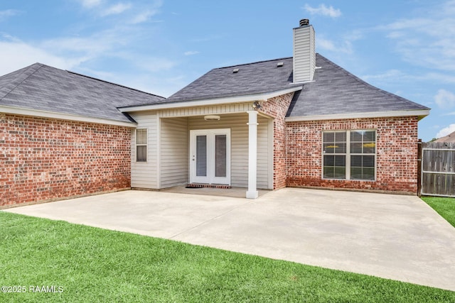 117 Fawn Ln, Broussard, LA 70518 - rear view of house featuring brick siding, a patio, a chimney, and french doors