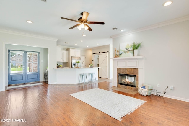 117 Fawn Ln, Broussard, LA 70518 - living area featuring ornamental molding, light wood-style flooring, ceiling fan, recessed lighting, and a barn door