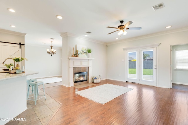 117 Fawn Ln, Broussard, LA 70518 - living area featuring a barn door, light wood-type flooring, a ceiling fan, recessed lighting, and a fireplace