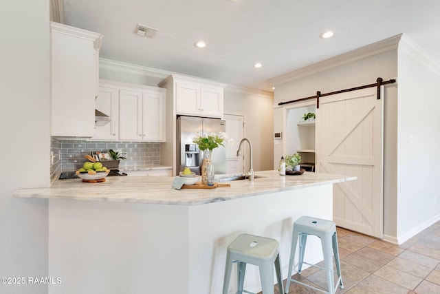 117 Fawn Ln, Broussard, LA 70518 - kitchen with stainless steel refrigerator with ice dispenser, crown molding, white cabinets, backsplash, and light stone countertops