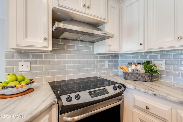 117 Fawn Ln, Broussard, LA 70518 - kitchen featuring stainless steel electric range, wall chimney exhaust hood, white cabinetry, and backsplash