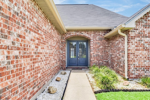 117 Fawn Ln, Broussard, LA 70518 - property entrance featuring brick siding, roof with shingles, and french doors