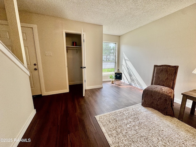 201 High Meadows Blvd Unit 205, Lafayette, LA 70507 - sitting room with wood finished floors, baseboards, and a textured ceiling