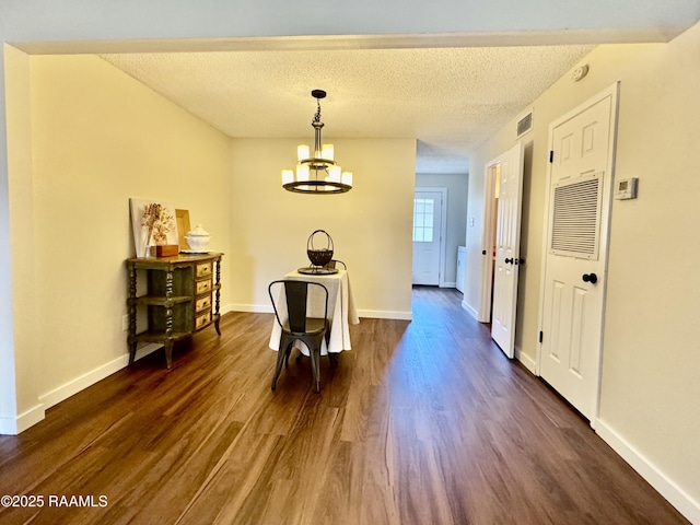 201 High Meadows Blvd Unit 205, Lafayette, LA 70507 - corridor featuring dark wood-style flooring, a chandelier, a textured ceiling, and baseboards