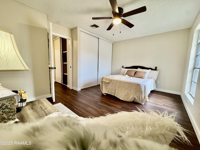 201 High Meadows Blvd Unit 205, Lafayette, LA 70507 - bedroom featuring a closet, wood finished floors, a textured ceiling, baseboards, and ceiling fan