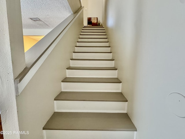 201 High Meadows Blvd Unit 205, Lafayette, LA 70507 - stairs with a textured ceiling