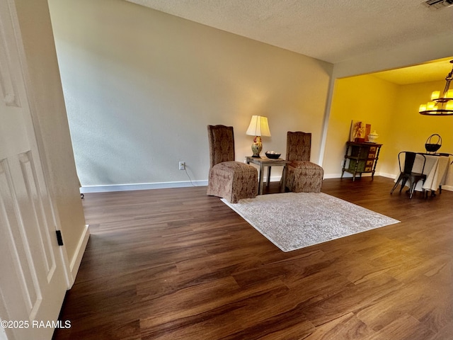 201 High Meadows Blvd Unit 205, Lafayette, LA 70507 - living area with wood finished floors, a chandelier, baseboards, and a textured ceiling