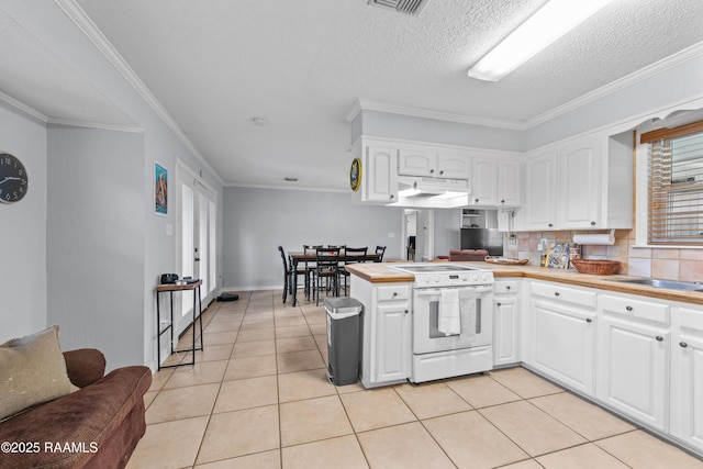 315 Orgeron Dr, Lafayette, LA 70506 - kitchen with white range with electric cooktop, under cabinet range hood, white cabinetry, a peninsula, and light tile patterned floors
