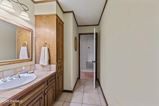 315 Orgeron Dr, Lafayette, LA 70506 - bathroom featuring ornamental molding, tile patterned floors, vanity, and a textured ceiling