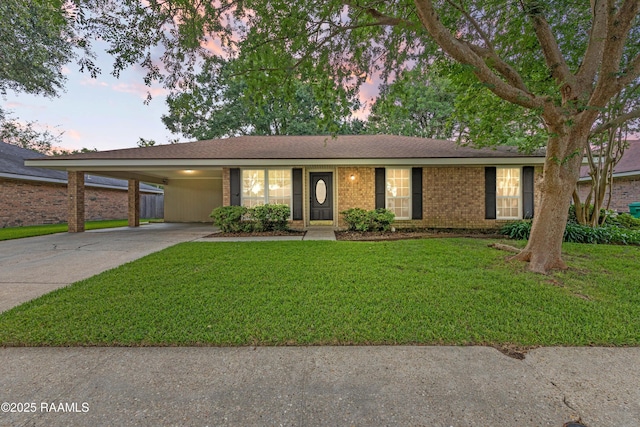 315 Orgeron Dr, Lafayette, LA 70506 - ranch-style home featuring concrete driveway, a carport, a yard, and brick siding