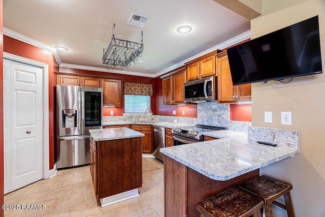202 Doe Ln, Broussard, LA 70518 - kitchen featuring stainless steel appliances, a peninsula, brown cabinetry, ornamental molding, and tasteful backsplash