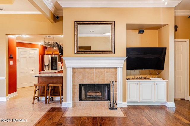 202 Doe Ln, Broussard, LA 70518 - living area featuring ornamental molding, light wood finished floors, and a tile fireplace