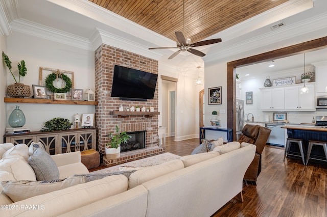 302 Easy Rock Landing Dr, Broussard, LA 70518 - living room with a ceiling fan, dark wood-style flooring, ornamental molding, a brick fireplace, and recessed lighting