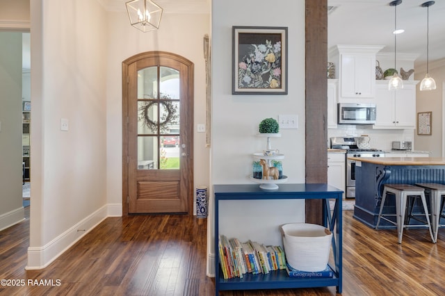 302 Easy Rock Landing Dr, Broussard, LA 70518 - foyer featuring ornamental molding, dark wood-style flooring, a chandelier, and arched walkways