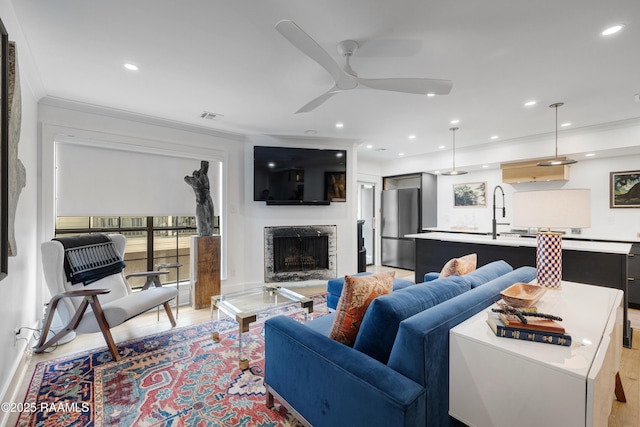 1304 E Bayou Pkwy Unit 8A, Lafayette, LA 70508 - living room with ceiling fan, ornamental molding, a fireplace, recessed lighting, and light wood-type flooring