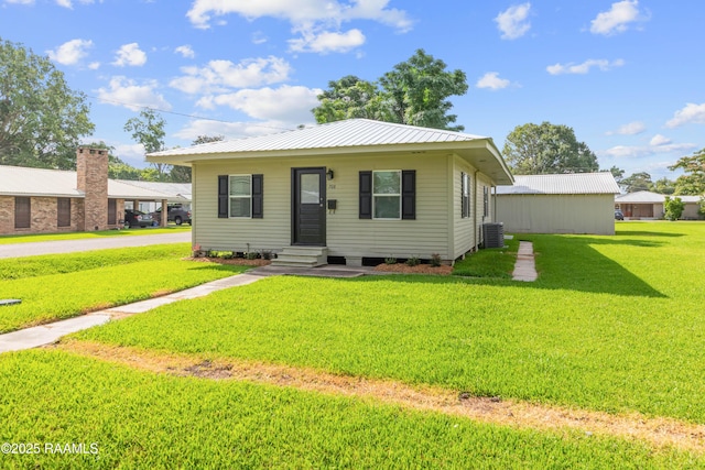 708 Park Ave, Breaux Bridge, LA 70517 - bungalow featuring a front yard, a metal roof, and entry steps