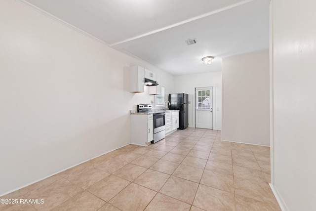 708 Park Ave, Breaux Bridge, LA 70517 - kitchen with stainless steel range with electric cooktop, under cabinet range hood, white cabinetry, freestanding refrigerator, and light tile patterned floors
