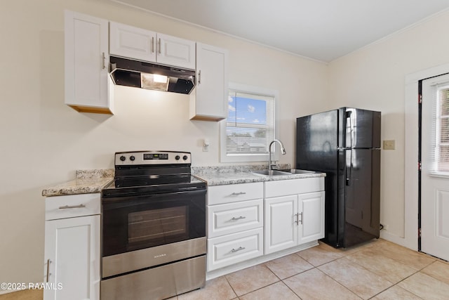 708 Park Ave, Breaux Bridge, LA 70517 - kitchen with stainless steel range with electric cooktop, under cabinet range hood, freestanding refrigerator, white cabinets, and light tile patterned flooring