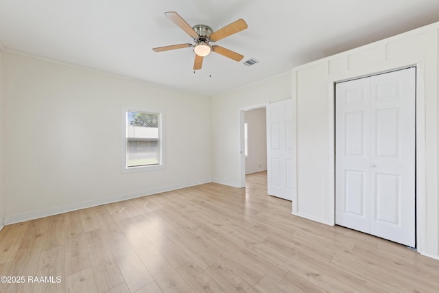 708 Park Ave, Breaux Bridge, LA 70517 - unfurnished bedroom with crown molding, light wood-type flooring, ceiling fan, and a closet