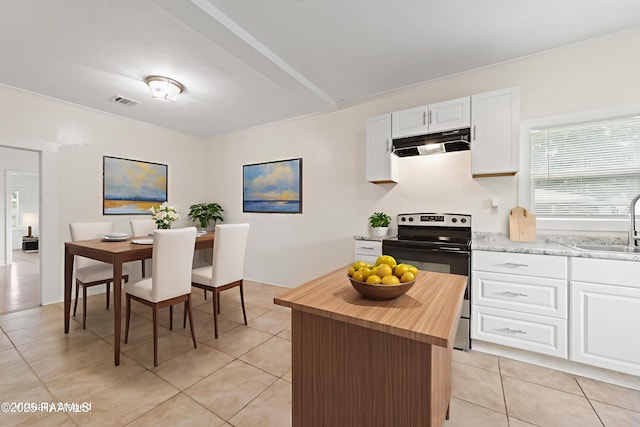 708 Park Ave, Breaux Bridge, LA 70517 - kitchen featuring range with electric cooktop, under cabinet range hood, wood counters, light tile patterned floors, and white cabinetry