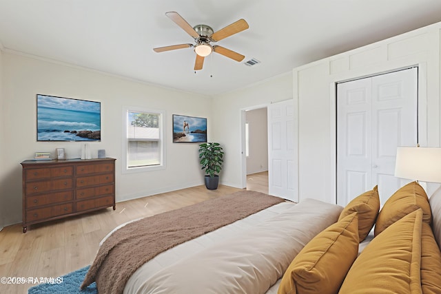 708 Park Ave, Breaux Bridge, LA 70517 - bedroom featuring ornamental molding, light wood finished floors, ceiling fan, and a closet