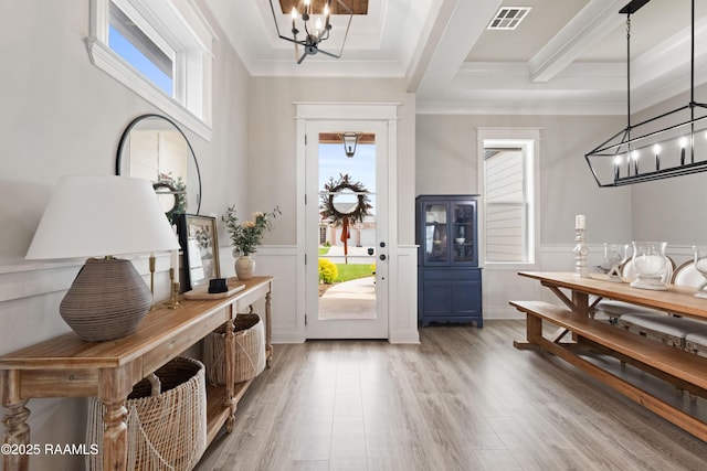 236 Whispering Meadows Rd, Broussard, LA 70518 - entryway with a chandelier, healthy amount of natural light, light wood-type flooring, a decorative wall, and a wainscoted wall