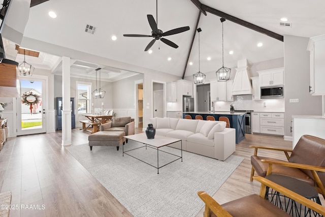 236 Whispering Meadows Rd, Broussard, LA 70518 - living room featuring beam ceiling, ceiling fan, light wood-style flooring, a chandelier, and wainscoting