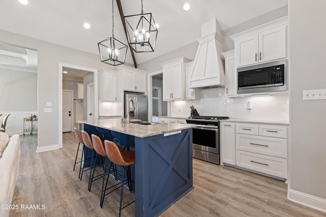 236 Whispering Meadows Rd, Broussard, LA 70518 - kitchen with stainless steel appliances, tasteful backsplash, white cabinetry, light wood-style floors, and a breakfast bar area