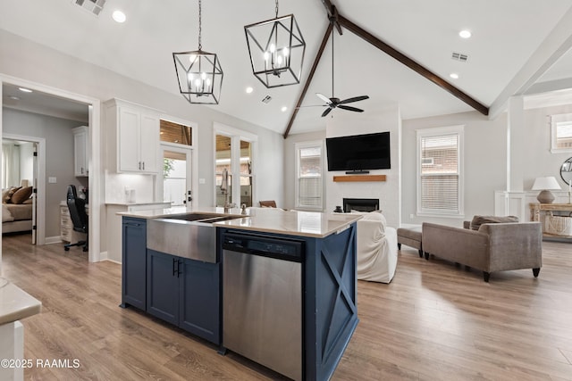 236 Whispering Meadows Rd, Broussard, LA 70518 - kitchen featuring dishwasher, open floor plan, blue cabinets, a kitchen island with sink, and white cabinets