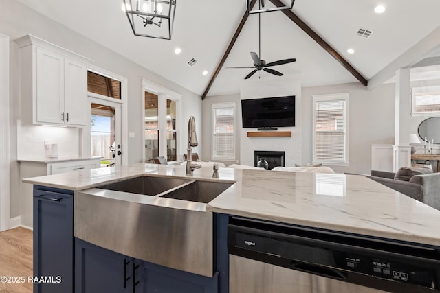 236 Whispering Meadows Rd, Broussard, LA 70518 - kitchen with open floor plan, dishwasher, a large fireplace, blue cabinetry, and recessed lighting