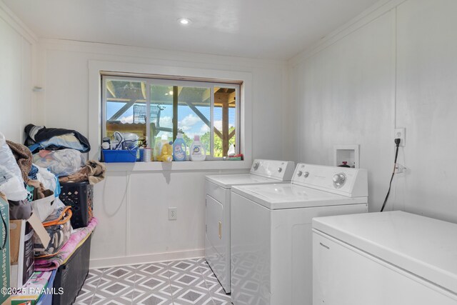 145 Celestine Ln, Sunset, LA 70584 - laundry room featuring washing machine and clothes dryer, light floors, and crown molding