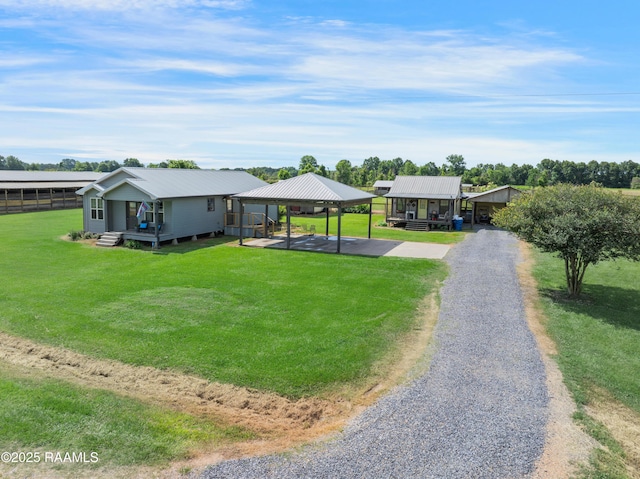 145 Celestine Ln, Sunset, LA 70584 - view of front facade with a detached carport, driveway, a front lawn, and a metal roof