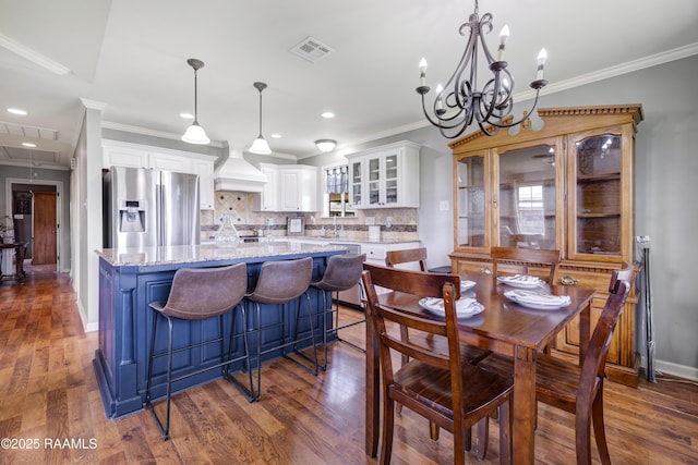 145 Celestine Ln, Sunset, LA 70584 - dining space featuring dark wood finished floors, a chandelier, crown molding, recessed lighting, and attic access