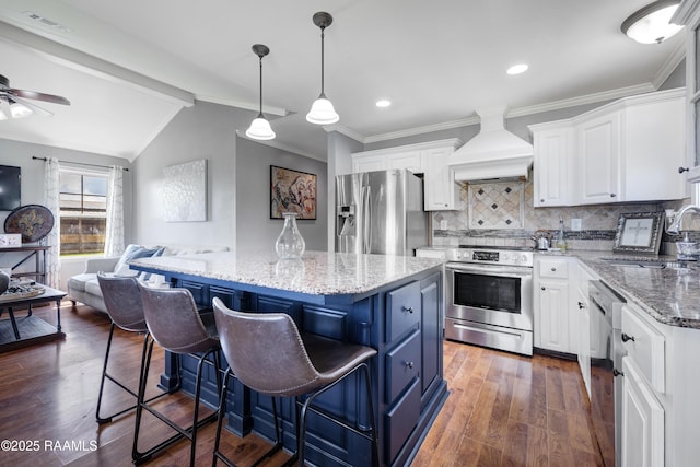 145 Celestine Ln, Sunset, LA 70584 - kitchen featuring appliances with stainless steel finishes, premium range hood, open floor plan, white cabinetry, and a kitchen island