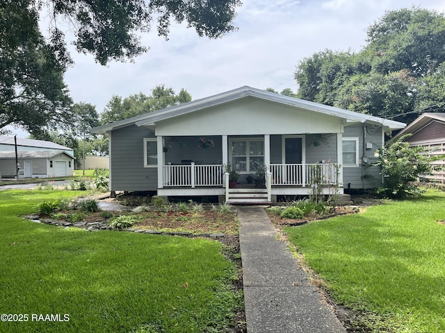 bungalow with covered porch and a front yard