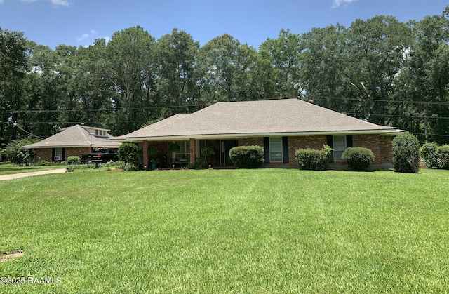 1921 E Willow St, Lafayette, LA 70501 - view of front of house featuring a front lawn and brick siding