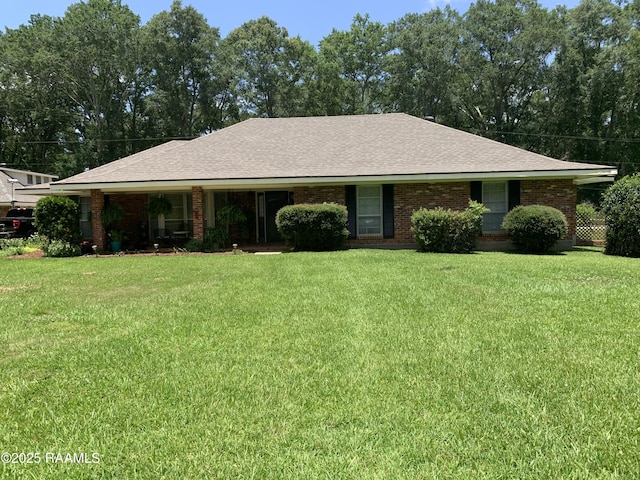 1921 E Willow St, Lafayette, LA 70501 - ranch-style house with a front yard, brick siding, and a shingled roof