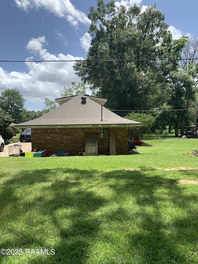 1921 E Willow St, Lafayette, LA 70501 - view of home's exterior with a lawn and brick siding