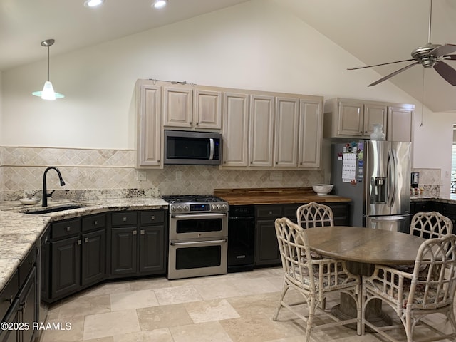 1921 E Willow St, Lafayette, LA 70501 - kitchen with appliances with stainless steel finishes, a ceiling fan, backsplash, high vaulted ceiling, and light stone countertops