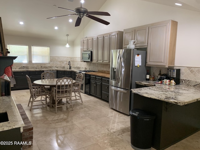 1921 E Willow St, Lafayette, LA 70501 - kitchen featuring appliances with stainless steel finishes, a ceiling fan, a peninsula, backsplash, and light stone counters