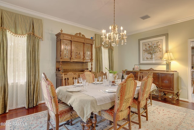 313 Darby Ln, New Iberia, LA 70560 - dining area with a chandelier, wood finished floors, and ornamental molding