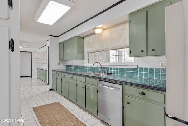 301 Broadmoor Blvd, Lafayette, LA 70503 - kitchen with stainless steel dishwasher, green cabinetry, light tile patterned flooring, and freestanding refrigerator