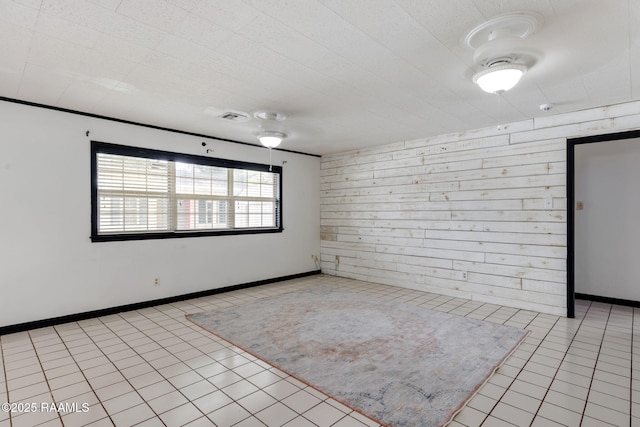 301 Broadmoor Blvd, Lafayette, LA 70503 - unfurnished room with light tile patterned floors, wooden walls, and a smoke detector
