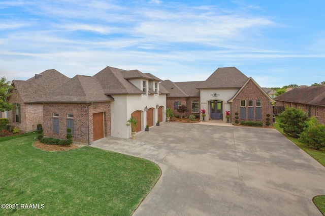 121 Snapping Ln, Broussard, LA 70518 - french provincial home featuring driveway, a front yard, brick siding, roof with shingles, and a garage